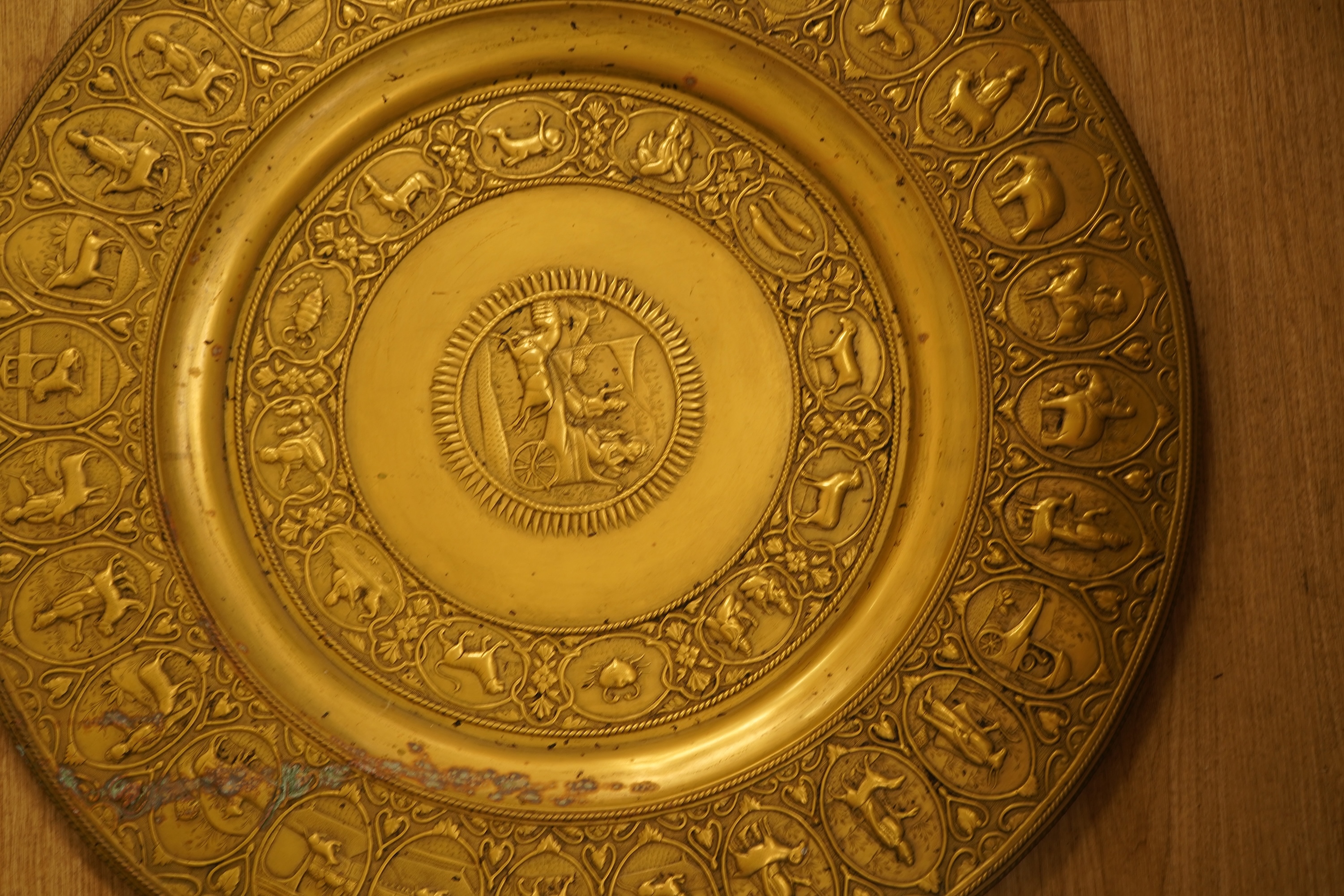 A large early 20th century Indian embossed brass tray, 78cm in diameter